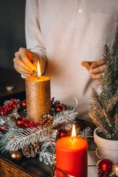 Close up of lighting first candle on Advent Wreath Celebrating Christmas or n Stock Photos