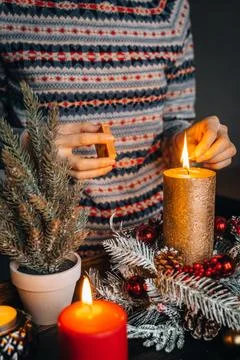 Close up of lighting first candle on Advent Wreath Celebrating Christmas or n Stock Photos