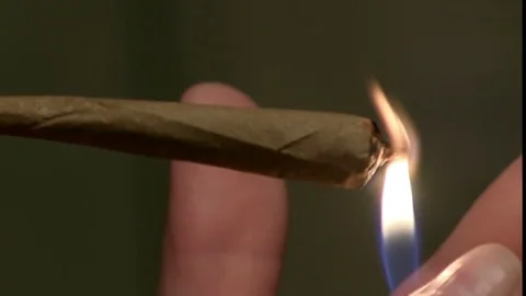 Close up of lighting Marijuana joint Stock Footage 75335119