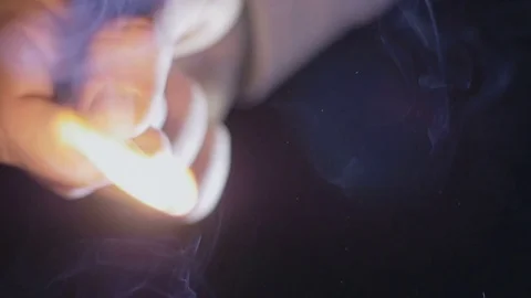Close-up of lighting a match in the dark Stock Footage 75547109
