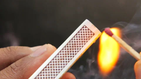 Close up of lighting a match Stock Footage 164464733