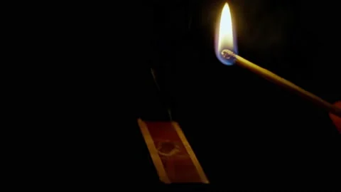 Close up of lighting a match isolated on black background Stock Footage 162769756