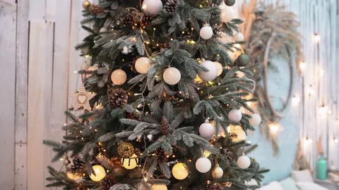 Close to the lights of a living fir tree, decorated with white globes, Stock-Footage 145282913