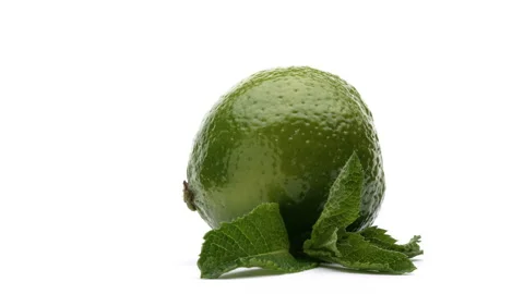 Close-up of a lime and mint leaves on white background. Stock Footage 157813206