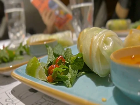 Close-up lime, paper, mint vietnamese spring rolls on the table Stock Footage 81536643