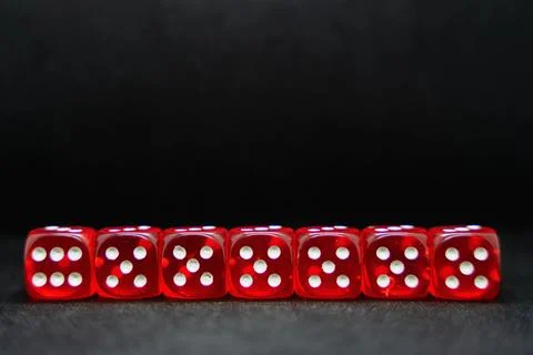 Close up of a line of red dice isolated on a black background Stock Photos