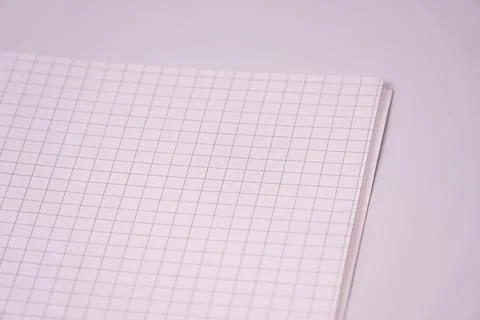Close up of lined notebook page, showcasing even grid lines, simple clean wor Stock Photos