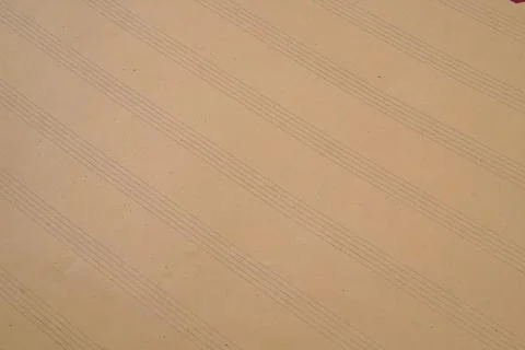 Close up of lined paper or envelope in brown color used as a background. Stock Photos