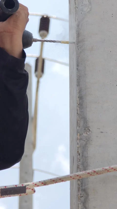 Close up of lineman worker hand using electric drill with masonry bit makin. Stock Footage 338175362