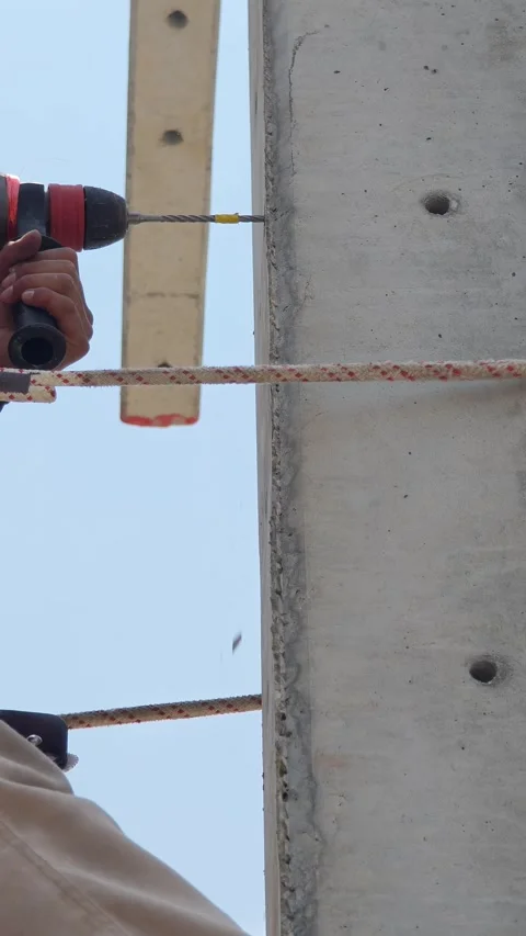 Close up of lineman worker hand using electric drill with masonry bit makin. Stock Footage 338175391