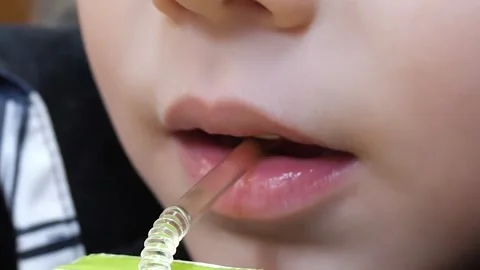 Close-up of the lips of a fair-skinned 5-year-old boy drinking Video stock 301639218