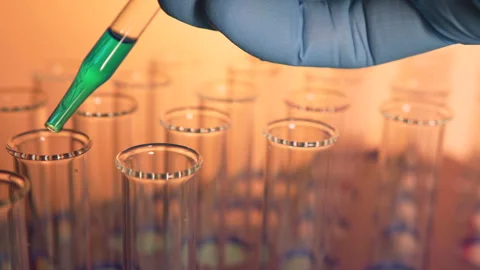 Close up liquid being dropped into a vial in a lab. Biotech, vaccine Видео 133878901