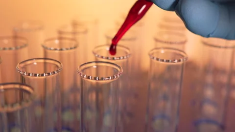 Close up liquid being dropped into a vial in a lab. Biotech, vaccine Stock-Footage 133879381