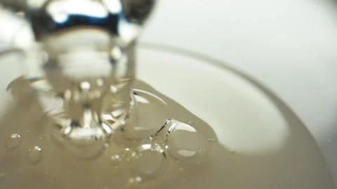 Close up of liquid being squeezed out of a pipette and sucked out of a bubble Stock Footage 293737931