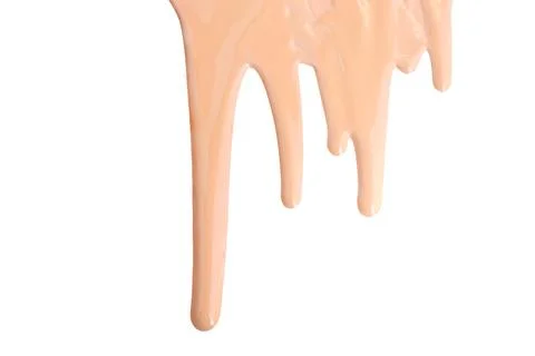 Close up of Liquid foundation sample flows down on a white background.  Stock Photos