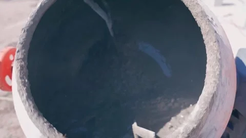 Close up of liquid inside a rotating concrete mixer in slow motion Stock Footage 311796753