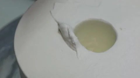 Close-up of Liquid Material Being Poured into a White Circular Mold for Industri Stock Footage 331777408