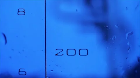 Close-up of liquid in a measuring beaker is poured in the laboratory Stock-Footage 45202853