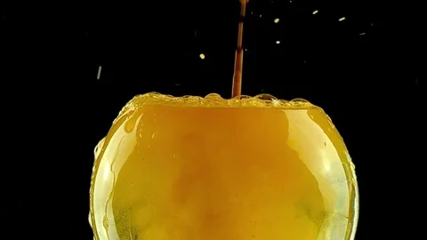 Close-up Liquid Orange Juice Splash on Black Background Video stock 334320672
