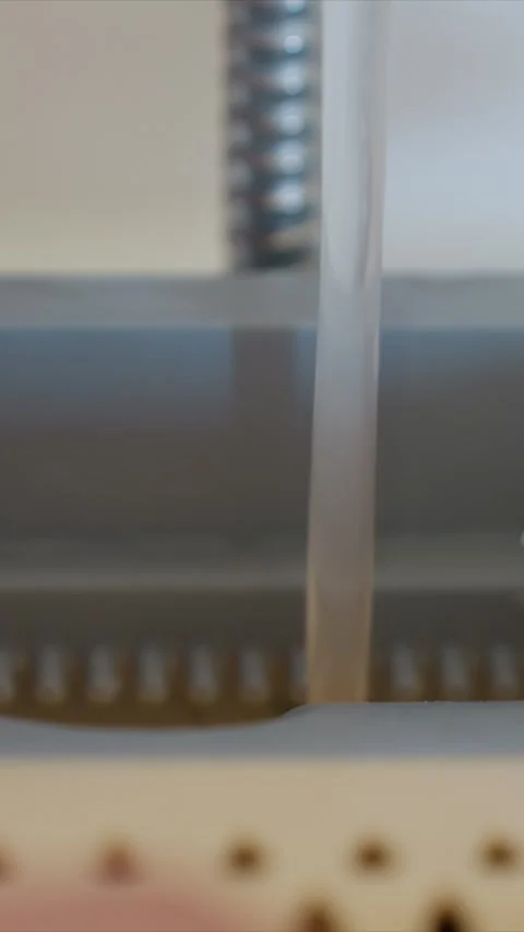 Close up of Liquid Stream Flowing Through Tube in Controlled Environment Stock Footage 346787035