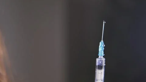 Close-up of the liquid in the syringe being sprayed out Stock Footage 260129774