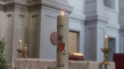 Close up of a lit decorated paschal candle in a church Stock Footage 332975995