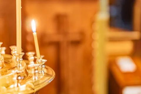Close-up of a lit menorah with multiple arms in a warmly-lit interior setting Stock Photos