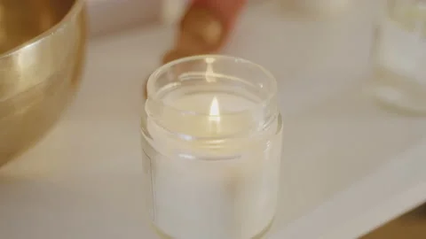 Close up lit white candle in transparent glass candlestick in spa salon beauty. Stock Footage 197595600