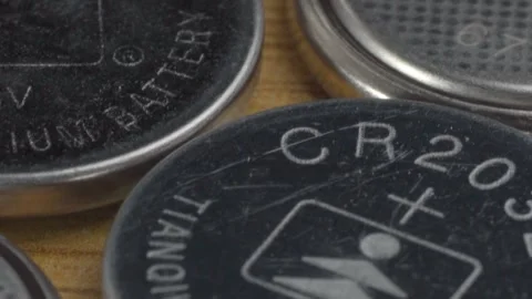 Close Up of Lithium Button Battery Showing CR2032 Markings and Warning Symbol Stock Footage 346796984