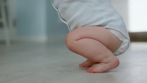 Close-up, little baby learning to take first steps. Slow motion video in 4K Stock Footage 302992132