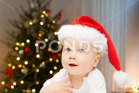 Close up of little baby in santa hat at christmas Stock Photos