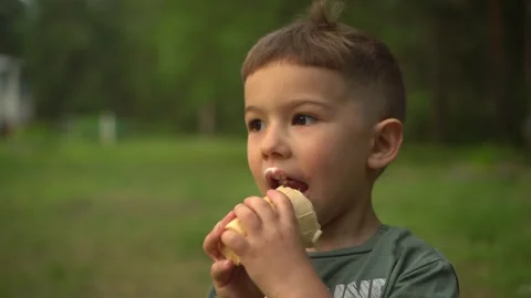Close Up of a Little Boy Eating Ice Cream in a Waffle Cone 動画素材 343894491