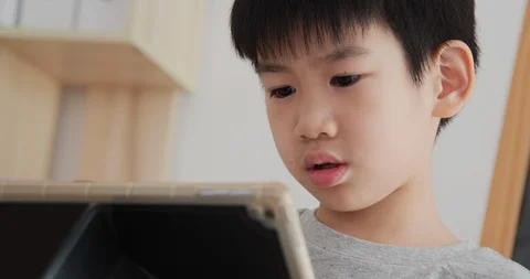 Close up little boy face using tablet at home. Stock Footage 129998079