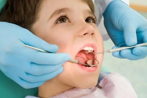 Close-up of little boy opening his mouth wide during inspection of oral cavity Stock Photos