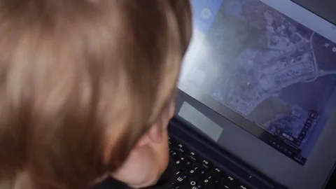 Close up of a little boy sitting on the floor and trying to learn with a Stock Footage 75348013