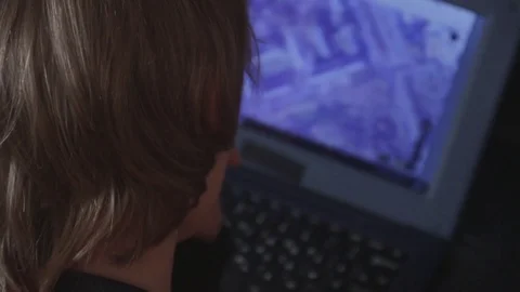 Close up of a little boy sitting on the floor and trying to learn with a Stock Footage 75348016