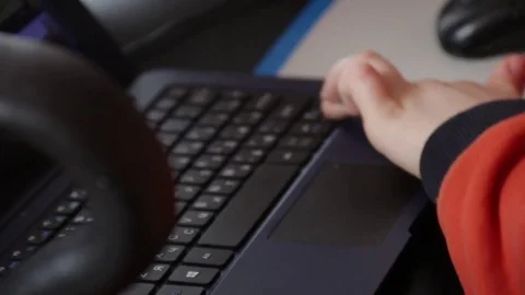 Close up of a little boy sitting on the floor and trying to learn with a Stock Footage 75348245