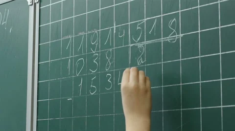 Close up of a little boy solves math on the chalkboard at school, Full HD shot Stock Footage 62530447