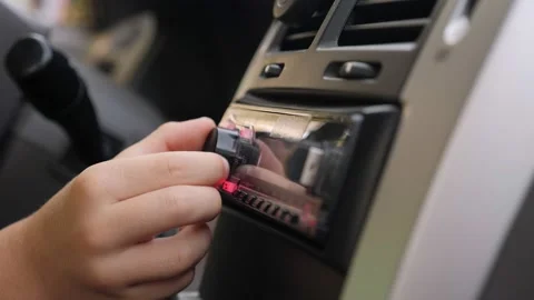Close-up of a little boy turning the volume on a radio in the car. Stock Footage 164206701