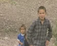 Close up of little children walking up stony slope SD Footage