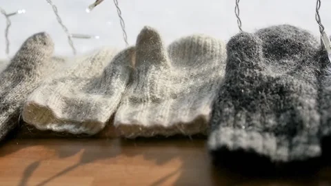 Close-up. Little fluff gloves dry on the window. Winter holiday concept. Stock Footage 154264356