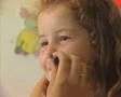 Close up of little girl getting her face painted SD Footage
