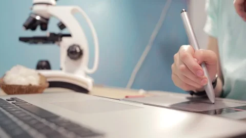 Close up on little girl learning using laptop and microscope. Video stock 90912447
