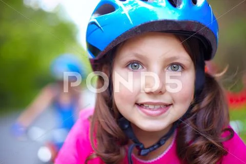 Close-up of a little girls face in helmet Stock Photos