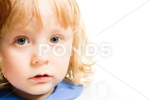 Close-up of little girls face looking at camera over white background Stock Photos