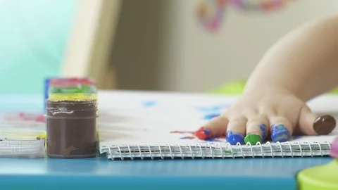 Close up of little hand covered in different color paint in slow mo. Stock Footage 85710015