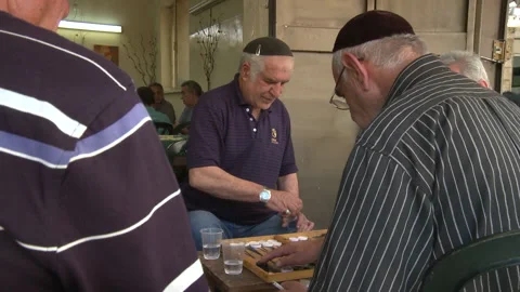 Close Up Of Live Backgammon Game and Zoom Out To See Jewish Men Rolling Dice Stock Footage 238646966