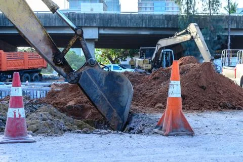 Close up of loader bucket working at construction site. Stock Photos
