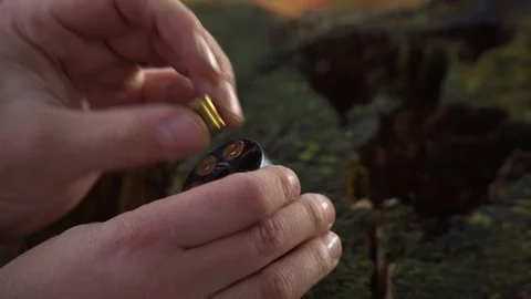 Close-up loading a bullet into a 6-gun revolver. Stock Footage 92668891