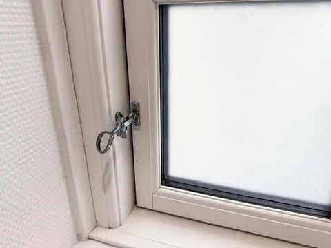 Close-up lock on closed window. Security concept Stock Photos